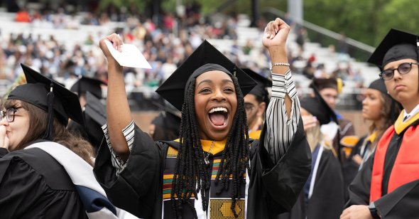 A graduate celebrates during Old Ƶ University’s undergraduate Commencement exercise Saturday, May 4, 2024.